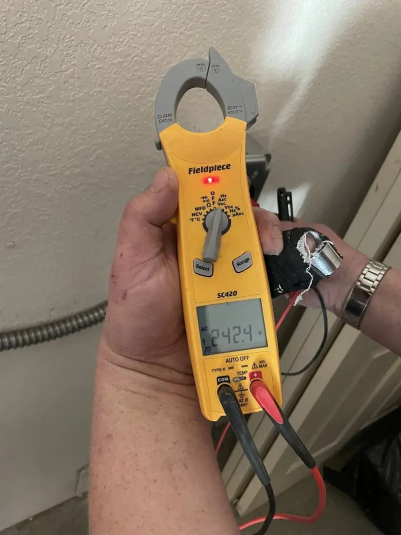 Voltage testing with clamp meter during Ceiling Fan Installation in Blackwell